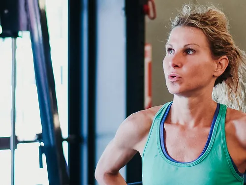 A runner at a gym takes a break between sets